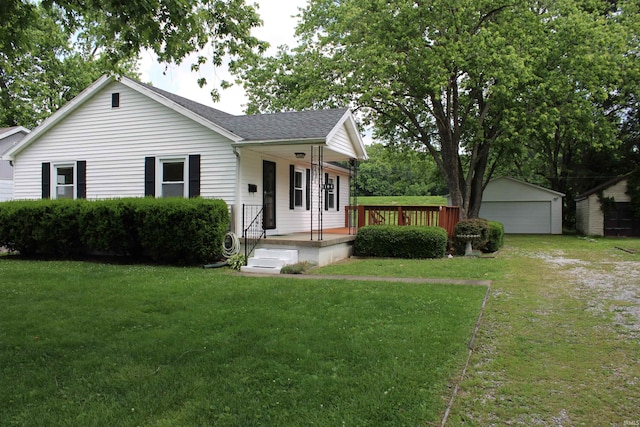 104 Tulip Ave, Evansville, IN 47711 - single story home featuring an outbuilding, a shingled roof, a front lawn, a garage, and a porch