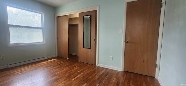 2703 Bosworth Dr, Fort Wayne, IN 46805 - unfurnished bedroom featuring baseboard heating, baseboards, dark wood-style flooring, and a closet