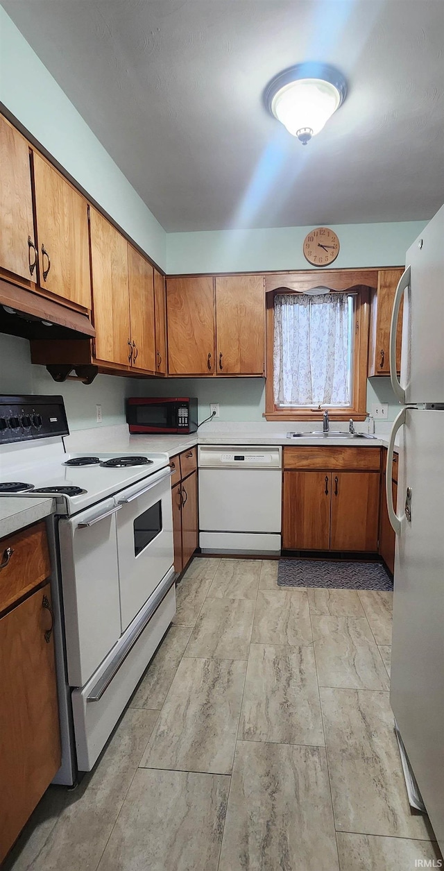 2703 Bosworth Dr, Fort Wayne, IN 46805 - kitchen featuring white appliances, brown cabinetry, under cabinet range hood, light countertops, and a sink