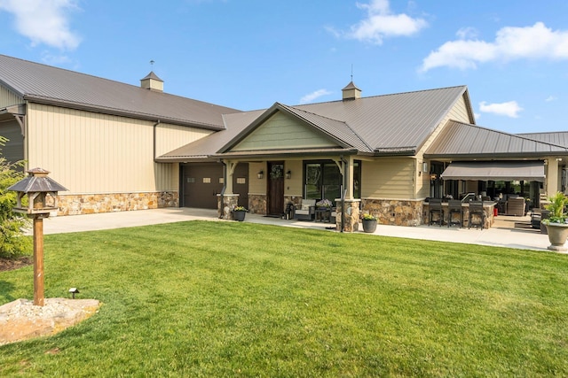 15306 Covington Rd, Fort Wayne, IN 46814 - back of house with stone siding, a yard, and a garage