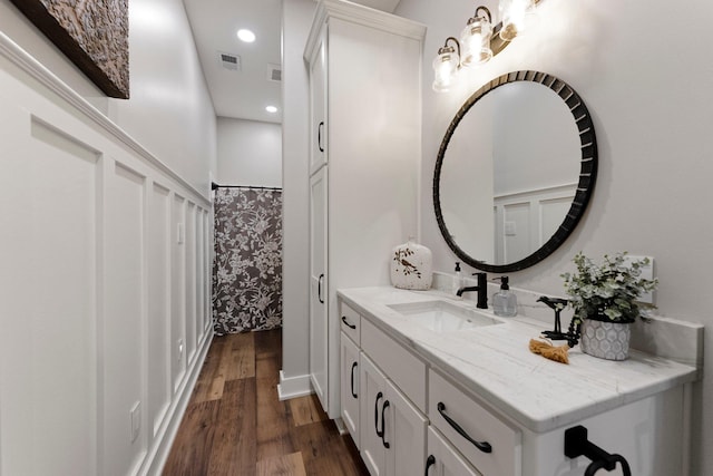 15306 Covington Rd, Fort Wayne, IN 46814 - bathroom with vanity, wood finished floors, and recessed lighting