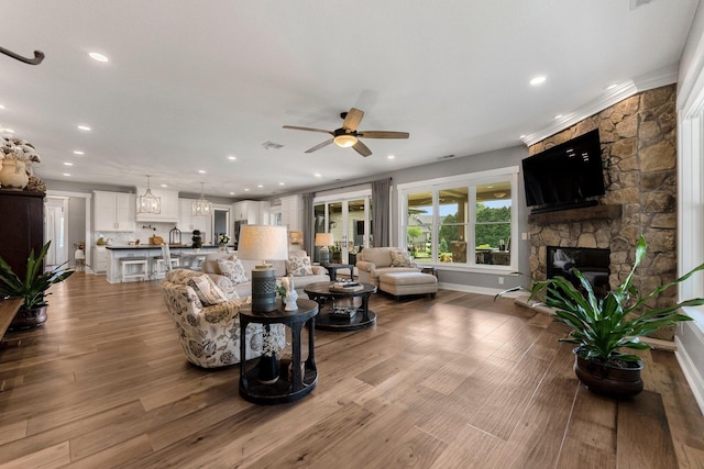 15306 Covington Rd, Fort Wayne, IN 46814 - living area with ceiling fan, recessed lighting, a fireplace, baseboards, and wood finished floors