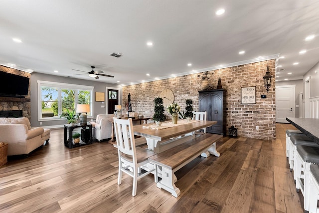 15306 Covington Rd, Fort Wayne, IN 46814 - dining space with a fireplace, a ceiling fan, wood finished floors, and recessed lighting