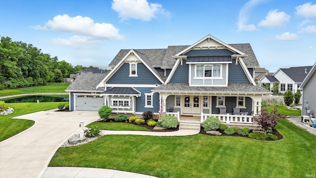 284 Savo Rock Ct, Fort Wayne, IN 46845 - view of front facade with a porch, driveway, a standing seam roof, a shingled roof, and an attached garage