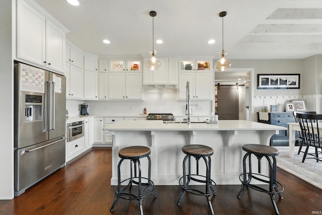 284 Savo Rock Ct, Fort Wayne, IN 46845 - kitchen with stainless steel appliances, a barn door, light countertops, white cabinets, and recessed lighting