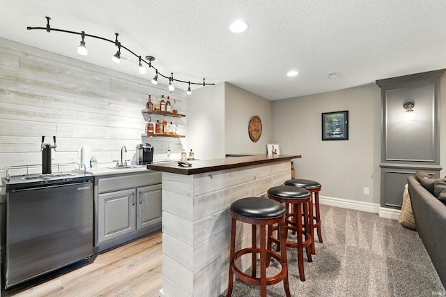 284 Savo Rock Ct, Fort Wayne, IN 46845 - indoor wet bar with baseboards, wood walls, recessed lighting, stove, and a textured ceiling