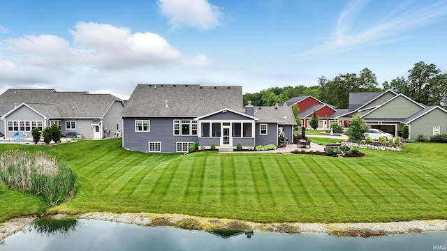 284 Savo Rock Ct, Fort Wayne, IN 46845 - rear view of house featuring a sunroom, a yard, entry steps, and roof with shingles