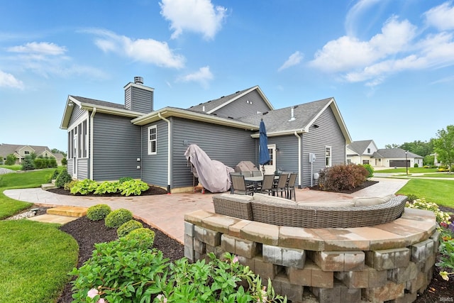 284 Savo Rock Ct, Fort Wayne, IN 46845 - back of house featuring a patio area and a chimney