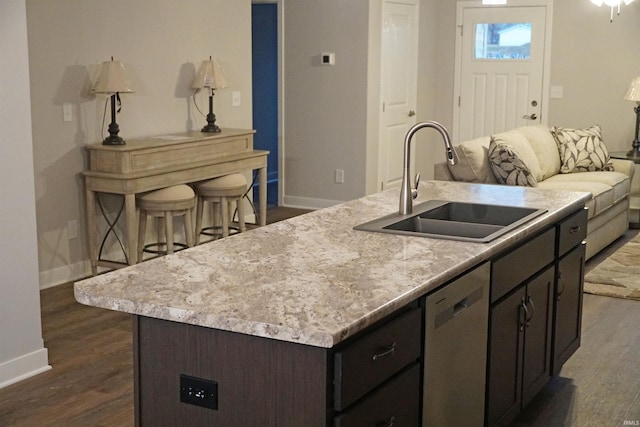 19 Conner St, Wabash, IN 46992 - kitchen featuring dishwasher, a sink, baseboards, dark brown cabinets, and a kitchen island with sink