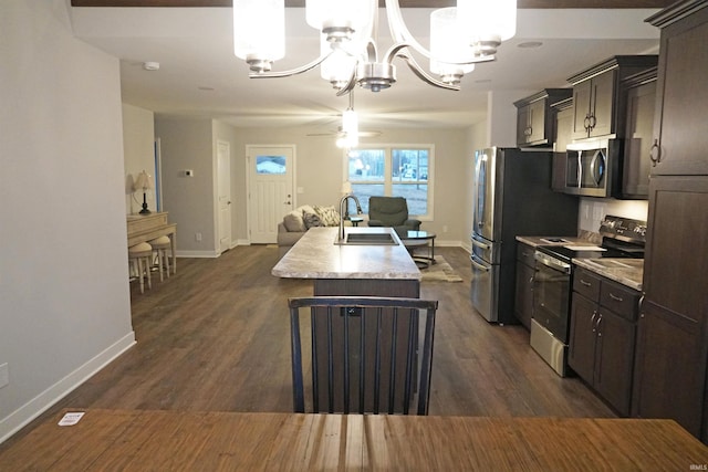 19 Conner St, Wabash, IN 46992 - kitchen featuring appliances with stainless steel finishes, a sink, a chandelier, baseboards, and light countertops