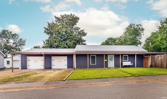301 S Mccreary St, Fort Branch, IN 47648 - view of front of house featuring board and batten siding, a garage, metal roof, and driveway