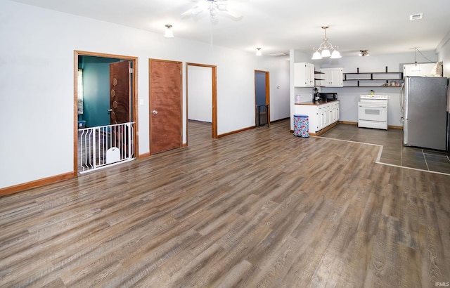 301 S Mccreary St, Fort Branch, IN 47648 - kitchen with white range, freestanding refrigerator, white cabinetry, black microwave, and baseboards