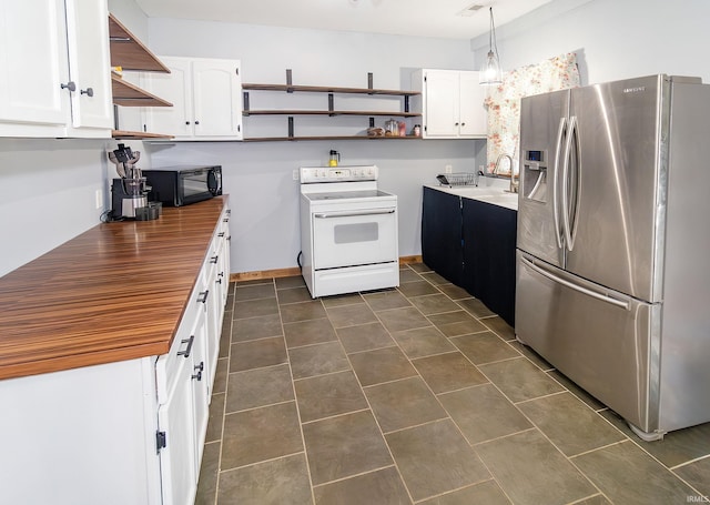 301 S Mccreary St, Fort Branch, IN 47648 - kitchen featuring stainless steel fridge, open shelves, electric range, and black microwave