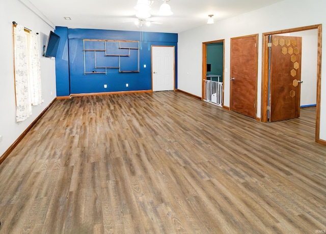 301 S Mccreary St, Fort Branch, IN 47648 - spare room featuring wood finished floors, baseboards, and a ceiling fan