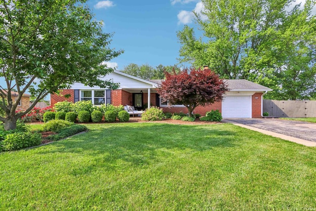 5987 E 100 N, Franklin, IN 46131 - view of front of house featuring asphalt driveway, a garage, brick siding, a chimney, and covered porch