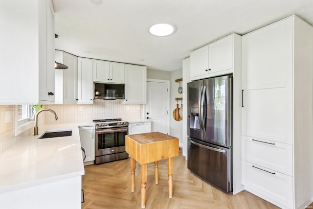 5987 E 100 N, Franklin, IN 46131 - kitchen with appliances with stainless steel finishes, a sink, white cabinetry, decorative backsplash, and light stone counters