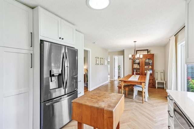 5987 E 100 N, Franklin, IN 46131 - kitchen with appliances with stainless steel finishes, a chandelier, wooden counters, white cabinets, and hanging light fixtures