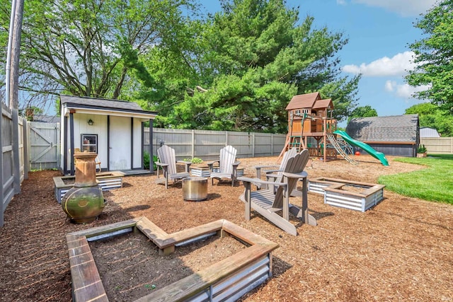 5987 E 100 N, Franklin, IN 46131 - fenced backyard with a playground, a fire pit, and a garden