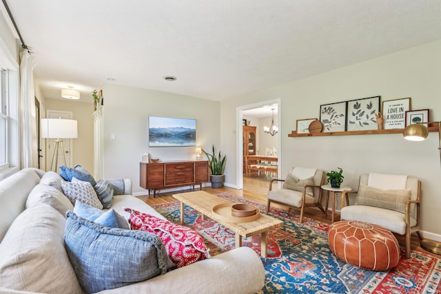 5987 E 100 N, Franklin, IN 46131 - living room with wood finished floors, a chandelier, and baseboards