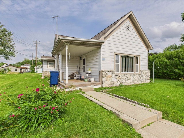 63 S Market St, Andrews, IN 46702 - view of front of house with a porch, stone siding, and a front lawn