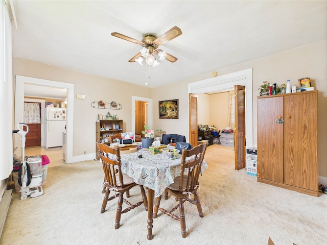 63 S Market St, Andrews, IN 46702 - dining space with a ceiling fan, light colored carpet, and baseboards