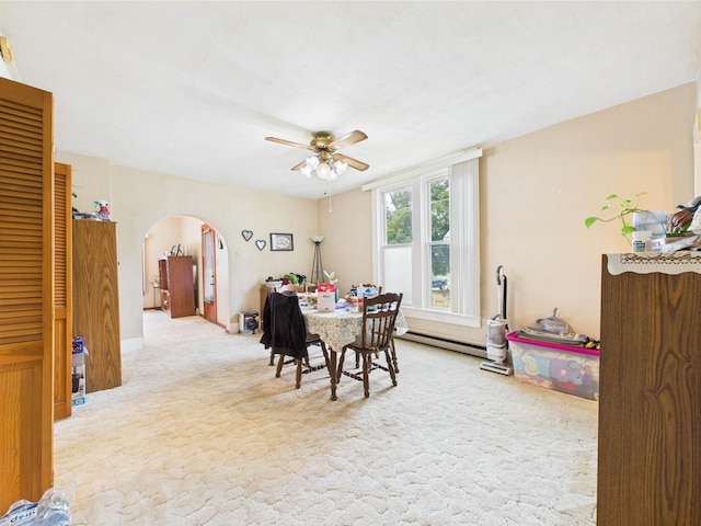 63 S Market St, Andrews, IN 46702 - carpeted dining area with arched walkways, ceiling fan, a baseboard heating unit, and baseboards
