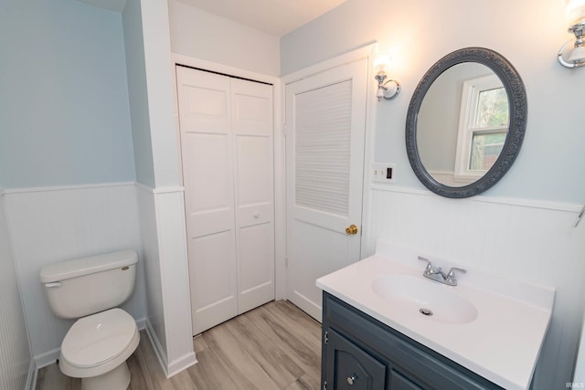 1307 Cassopolis St, Elkhart, IN 46514 - bathroom featuring wainscoting, vanity, toilet, wood finished floors, and a closet