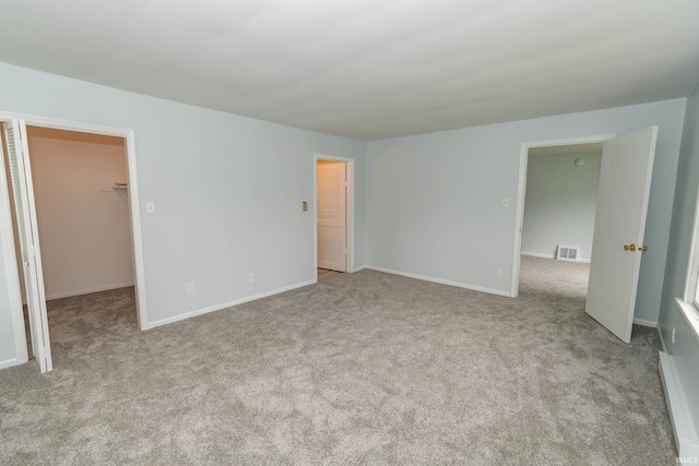 1307 Cassopolis St, Elkhart, IN 46514 - unfurnished bedroom with a spacious closet, carpet flooring, and baseboards