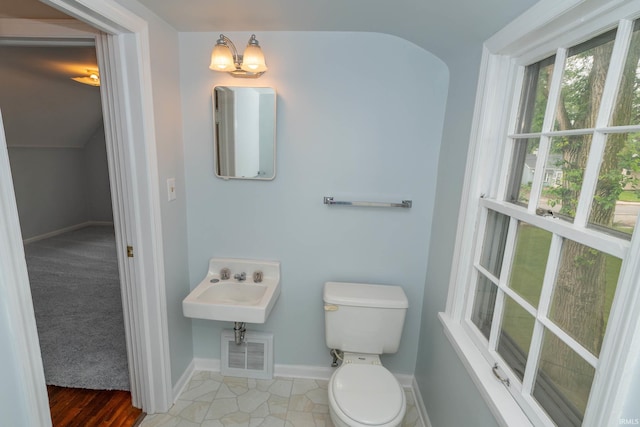 1307 Cassopolis St, Elkhart, IN 46514 - half bathroom with toilet, baseboards, and a sink