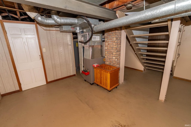 1307 Cassopolis St, Elkhart, IN 46514 - unfinished basement featuring baseboards, heating unit, and stairway