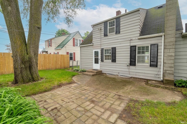 1307 Cassopolis St, Elkhart, IN 46514 - rear view of house with a chimney, a patio, and roof with shingles