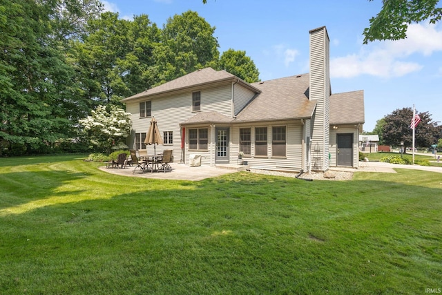 58679 Baugo Xing, Elkhart, IN 46517 - back of house with a patio, a yard, and a chimney