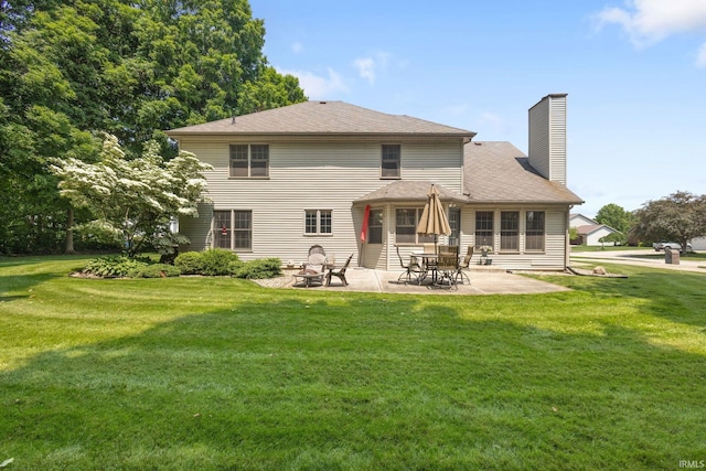 58679 Baugo Xing, Elkhart, IN 46517 - rear view of property with a chimney, a patio area, and a lawn
