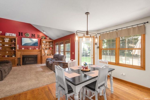 58679 Baugo Xing, Elkhart, IN 46517 - dining area featuring light wood finished floors, vaulted ceiling, and a fireplace
