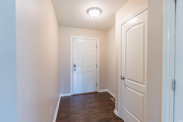 2502 Trillium Cv, Huntertown, IN 46748 - doorway featuring dark wood finished floors, baseboards, and a textured ceiling