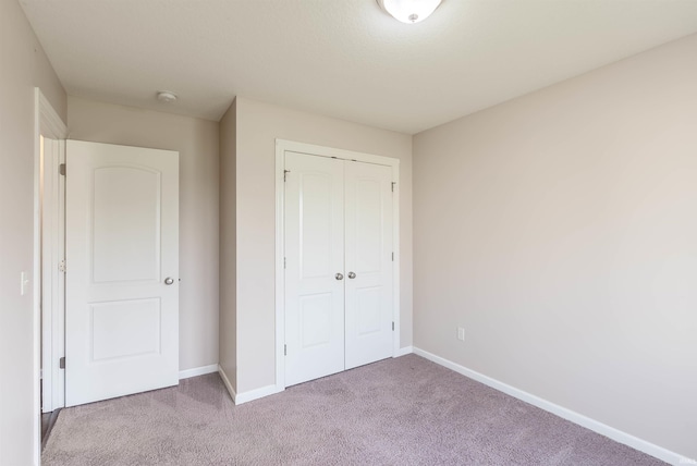 2502 Trillium Cv, Huntertown, IN 46748 - unfurnished bedroom featuring carpet, a closet, and baseboards