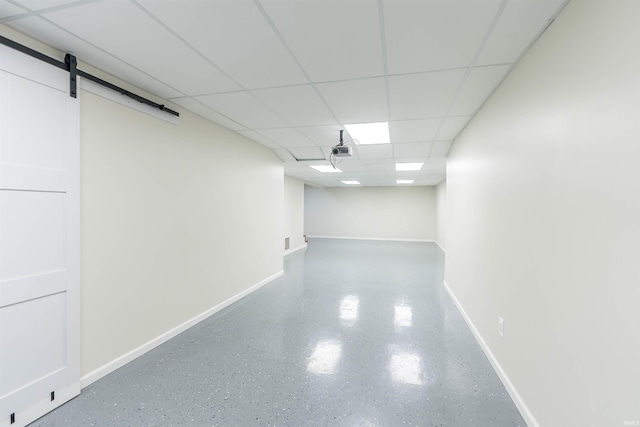 2502 Trillium Cv, Huntertown, IN 46748 - below grade area featuring baseboards, a paneled ceiling, and a barn door