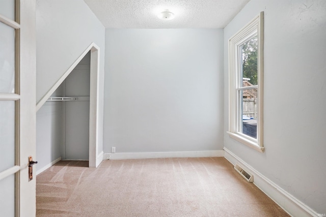 618 N Lake St, Warsaw, IN 46580 - unfurnished bedroom with a textured ceiling, carpet, a closet, and baseboards