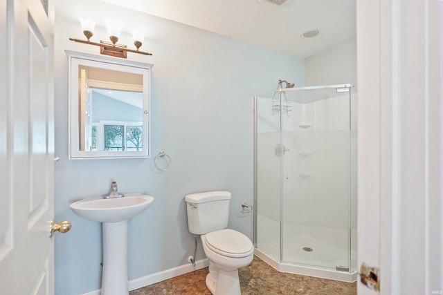 618 N Lake St, Warsaw, IN 46580 - bathroom with a stall shower, toilet, a sink, and baseboards