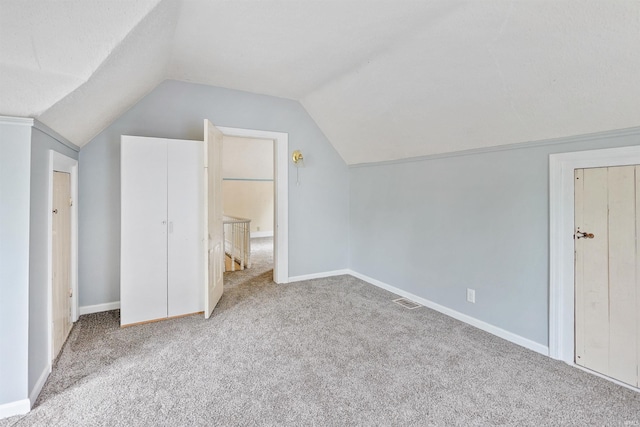 618 N Lake St, Warsaw, IN 46580 - unfurnished bedroom featuring carpet flooring, vaulted ceiling, and baseboards