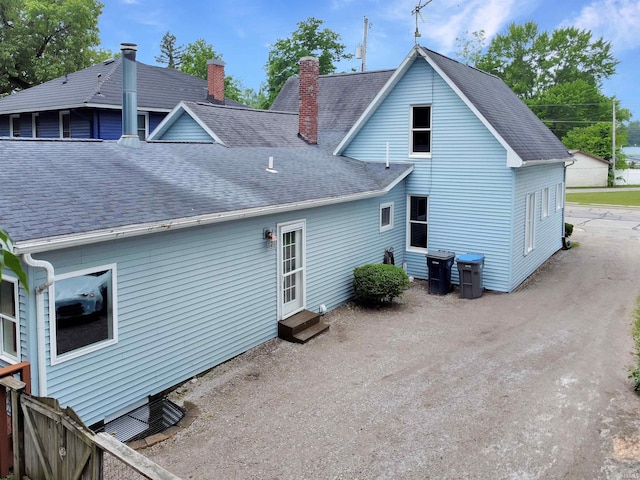 618 N Lake St, Warsaw, IN 46580 - back of property featuring entry steps, a chimney, and a shingled roof