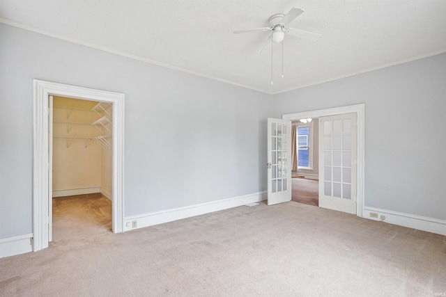618 N Lake St, Warsaw, IN 46580 - unfurnished bedroom with french doors, carpet flooring, crown molding, a walk in closet, and a closet