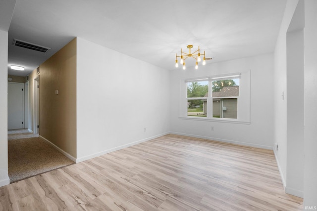 4654 Schmucker Dr, Fort Wayne, IN 46835 - empty room with a chandelier, light wood-style floors, and baseboards