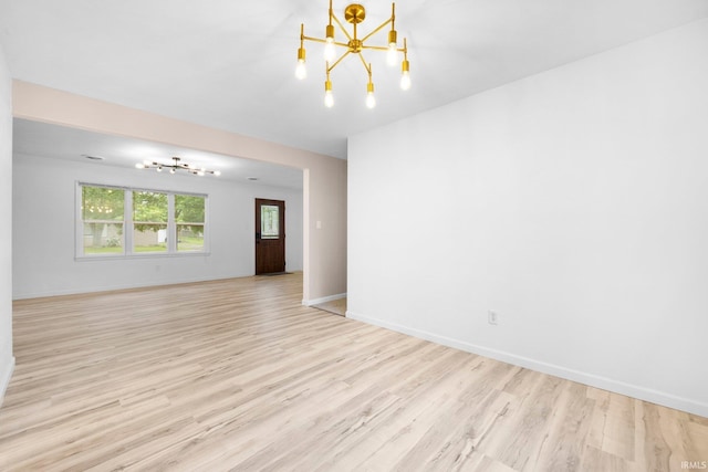 4654 Schmucker Dr, Fort Wayne, IN 46835 - unfurnished room with a chandelier, light wood-style flooring, and baseboards