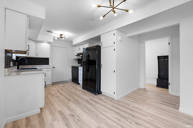4654 Schmucker Dr, Fort Wayne, IN 46835 - kitchen featuring black appliances, a sink, light countertops, light wood-type flooring, and white cabinets