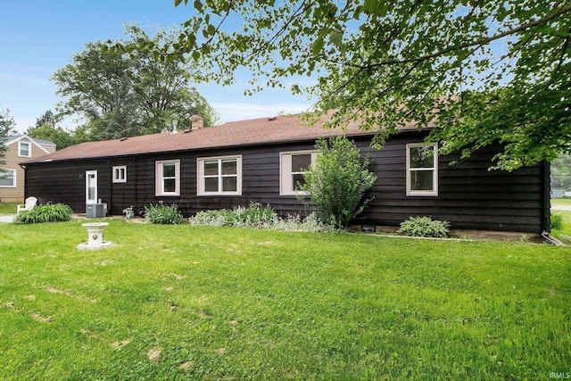 4654 Schmucker Dr, Fort Wayne, IN 46835 - rear view of property featuring a lawn, central AC unit, and a chimney