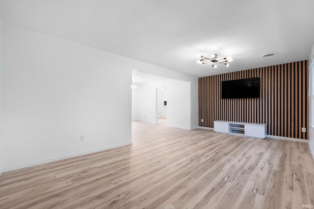 4654 Schmucker Dr, Fort Wayne, IN 46835 - unfurnished living room featuring a chandelier, light wood-type flooring, and baseboards