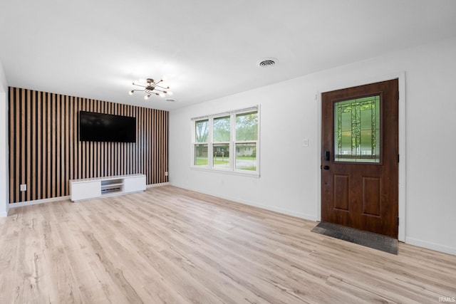 4654 Schmucker Dr, Fort Wayne, IN 46835 - unfurnished living room featuring a chandelier, wood finished floors, and baseboards