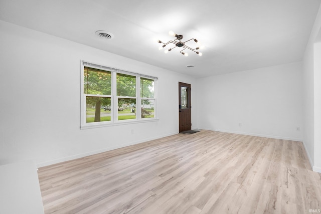 4654 Schmucker Dr, Fort Wayne, IN 46835 - spare room featuring a chandelier, wood finished floors, and baseboards