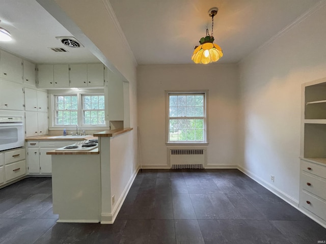 5425 Lincoln Ave, Evansville, IN 47715 - kitchen featuring radiator, white appliances, a sink, baseboards, and white cabinets
